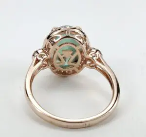 Rose gold ring with intricate design.