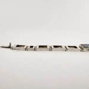 Silver bracelet with rectangular links and clasp.
