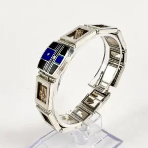 Silver bracelet with geometric inlay design.