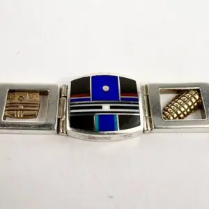 Silver bracelet with colorful geometric designs.