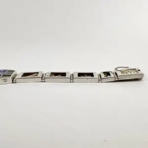 Silver charm bracelet with rectangular links.