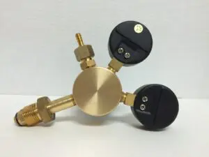 Brass pressure gauge with two black dials.
