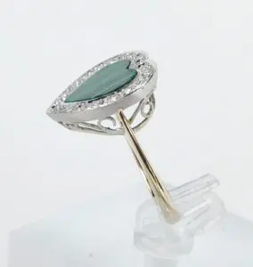 Heart-shaped ring with green gemstone.