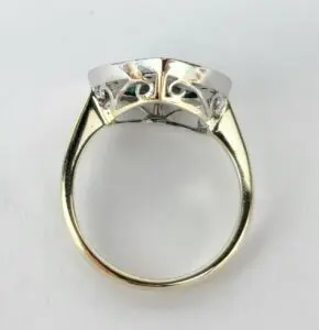 Gold and silver ring with intricate design.