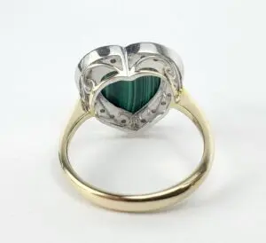 Heart-shaped ring with green gemstone.