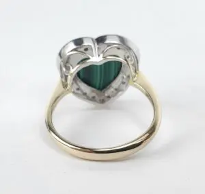 Heart-shaped gemstone ring with gold band.