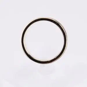 Gold ring on clear stand.