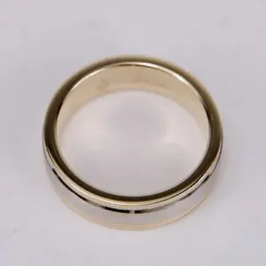 Gold and silver wedding band on display.