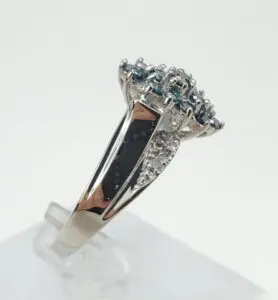 Silver ring with blue and clear stones.