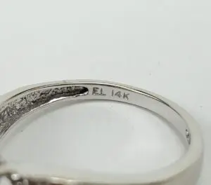 Close-up of ring with "14K" engraving.