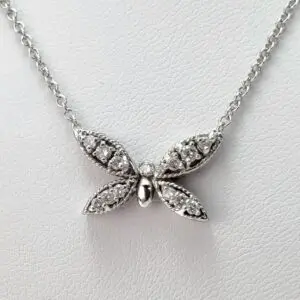Butterfly-shaped diamond pendant on silver chain.