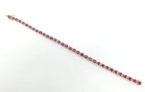 Ruby gemstone bracelet on white background.