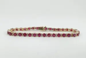 Gold bracelet with red gemstones.