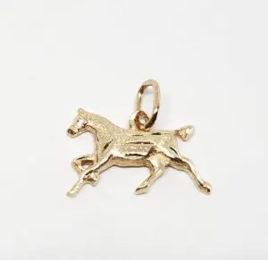Gold horse charm on white background.
