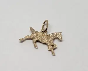 Gold horse charm on white background.