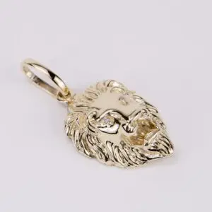 Gold lion head pendant with gemstones.