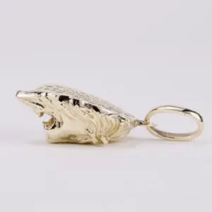 Gold wolf head pendant on white background.