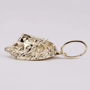 Golden lion head keychain on display.