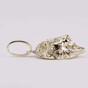 Gold lion head keychain on display.