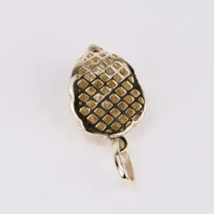 Gold pendant with textured grid pattern.