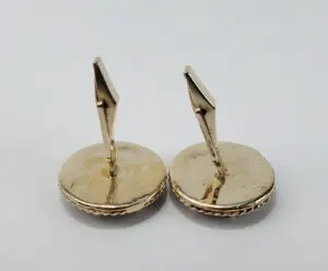 Gold cufflinks with round base.