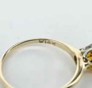 14K gold ring with gemstone setting.