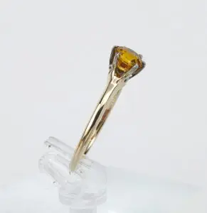 Gold ring with a yellow gemstone.