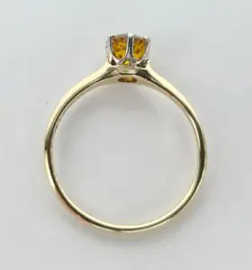 Gold ring with an amber gemstone.
