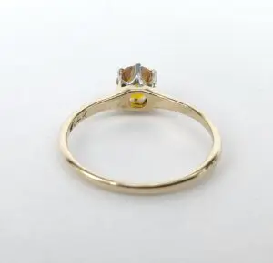 Gold ring with gemstone and small engraving.