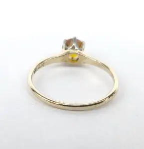Gold ring with solitaire diamond setting.
