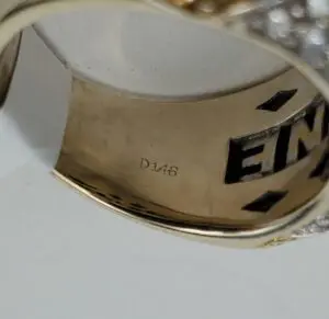 Close-up of engraved gold ring interior.