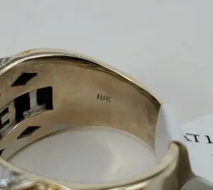 18K gold ring with engraved markings.