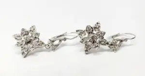 Silver floral earrings with sparkling stones.