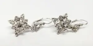 Silver floral earrings with crystal accents.