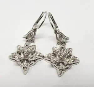 Silver star-shaped earrings with gemstone accents.