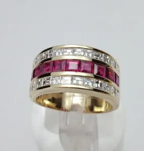 Gold ring with red and white stones.