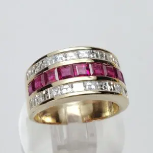 Gold ring with red and white stones.