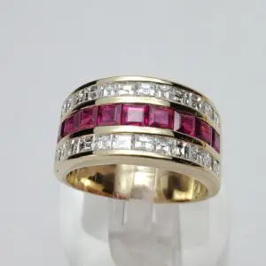 Gold ring with red and white stones.