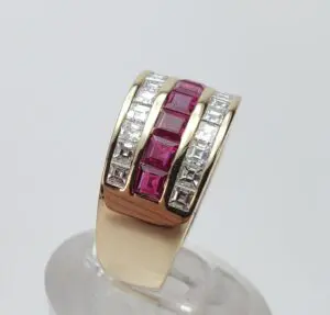 Gold ring with red and clear stones.