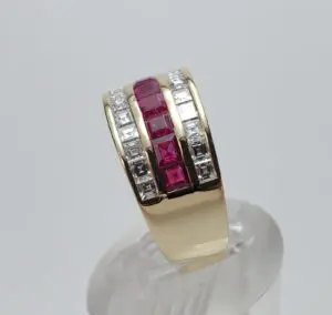 Gold ring with red and white stones.