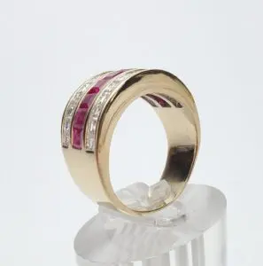 Gold ring with red and white stones.