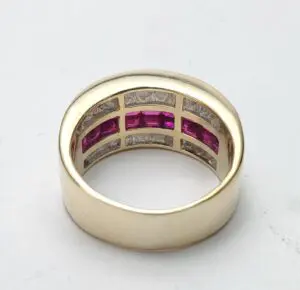 Gold ring with pink and clear stones.