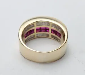 Gold ring with pink and clear stones.