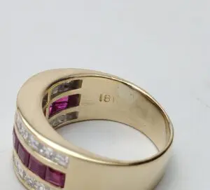 Gold ring with red and white stones.