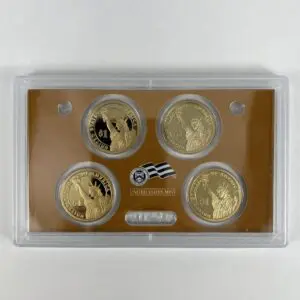 Four commemorative coins in display case.