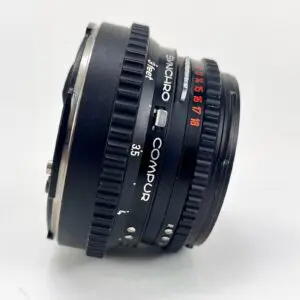 Black Synchro Compur camera lens, side view.