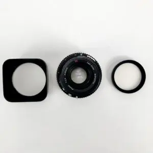 Camera lens with hood and filter.