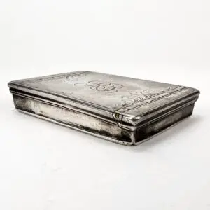 Engraved silver box with intricate details.
