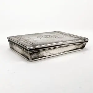 Rectangular silver box with engraved design.