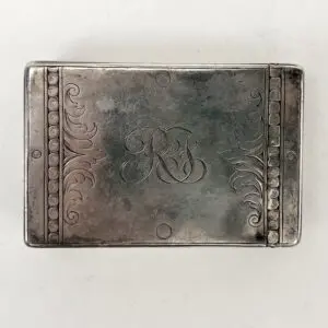 Engraved silver box with decorative patterns.